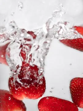 Hey fresh and cool fruites jumping in cold water. Stock Photos