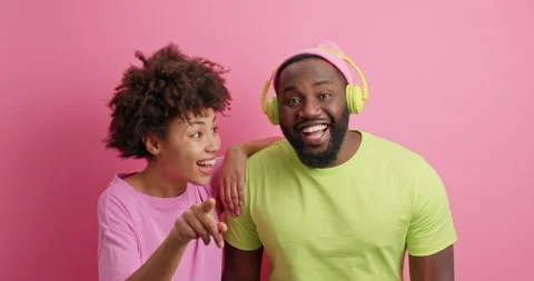 Hey look there. Positive Afro Americann woman points directly at camera shows Stock Footage 149915932