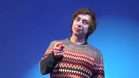 Hey you! Portrait of guy has trendy hairdo, points with fore finger at you Stock Footage 101920638