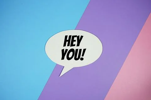Hey You! text on speech bubble top view on blue, purple and pink geometric .. Stock Illustration