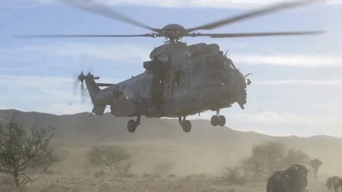 HH-60 Pave Hawk helicopter landing and kicking up dust Stock Footage 83985299