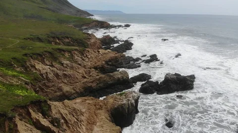 HHC192_Backing up from cliff revealing distant cliffside, tall mountains Stock Footage 116858444
