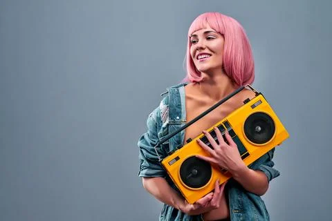 Hi, baby. Portrait of peaceful cool girl holding boom box with cassette tape  Stock Photos