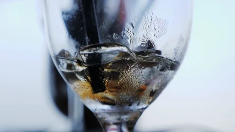 Hi key stirring ice in empty drink glass with straw in slow motion Stock Footage 102800599