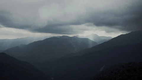 Hi Speed Cloud Moving A Beam of Light Penetrating the Clouds with Layer Mountain Stock Footage 129304048