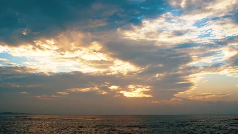Hi speed moving Cloudy against yellow light from sun on the ocean Stock Footage 153591254