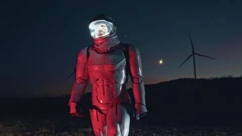 Hi-tech robot engineer on windmill farm checking the process looking around at Stock Photos