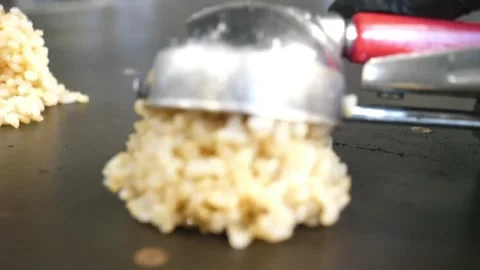 Hibachi Chef Scooping Fried Rice Onto Flat Top Griddle, Close Up Video stock 343028670