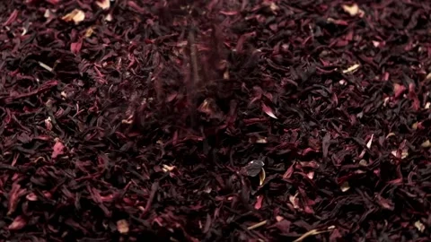 Hibiscus tea leaves falling down into a hibiscus. Circular miotion. Stock Footage 166385739