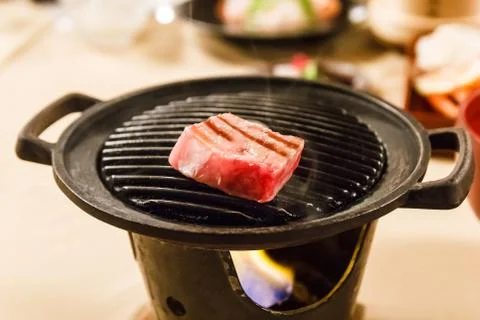 Hida beef on hot pan. Stock Photos