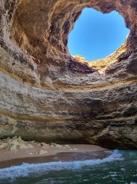 Hidden beach inside a cave. Stock Photos
