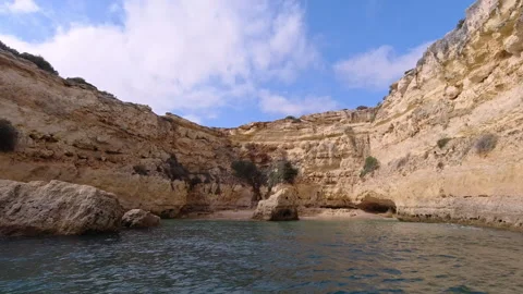 Hidden Beach Inside Limestone Sea Cave Accessible Only By Boat in Algarve P.. Video stock 310664074