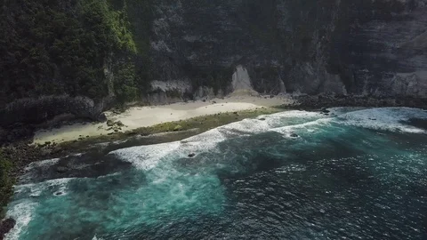 Hidden beach with the upcoming turquoise waves view from the ocean Stock Footage 101665762