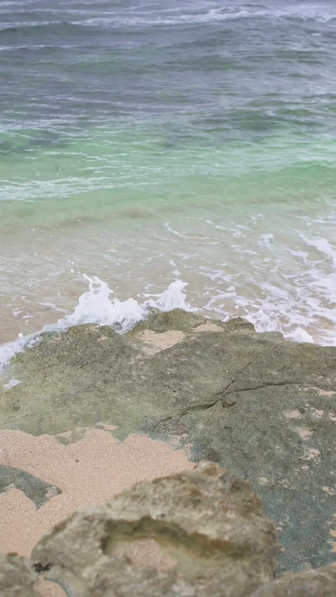 A hidden beach view featuring blue skies, white sand, and big waves. Stock Footage 324913870