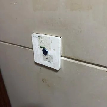 Hidden camera security device embedded in wall for surveillance Stock Photos