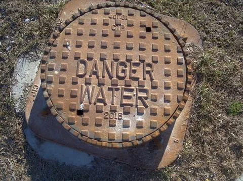 Hidden dangers beneath caution advised Stock Photos