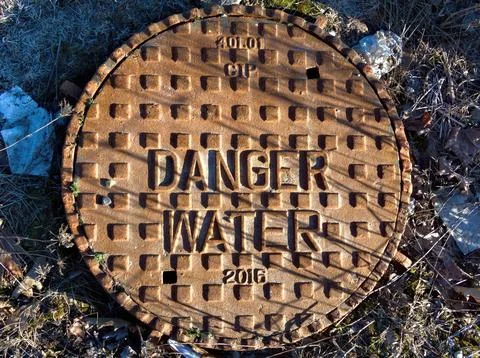 Hidden dangers beneath caution advised Stock Photos