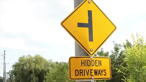 Hidden driveways rectangle sign with diamond sign above a sideways t Stock Footage 247754060