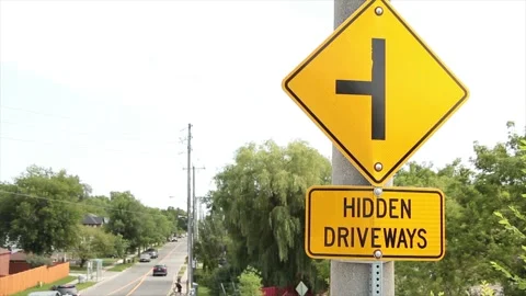 Hidden driveways rectangle sign with diamond sign above a sideways t Stock Footage 247754121