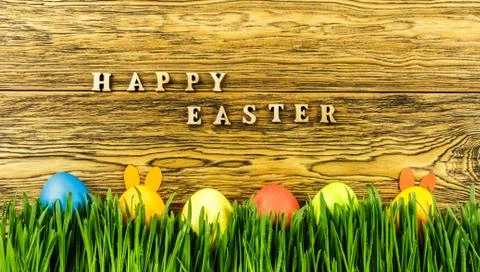 Hidden Easter Bunny in the grass. happy Easter. Ready greeting card design. Stock Photos