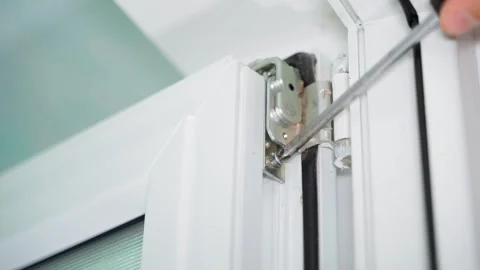 Hidden fastening of a plastic door to a loop. Assembly and installation of Stock Footage 245132292