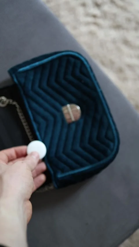 Hidden GPS tracker in handbag Stock Footage 336927698