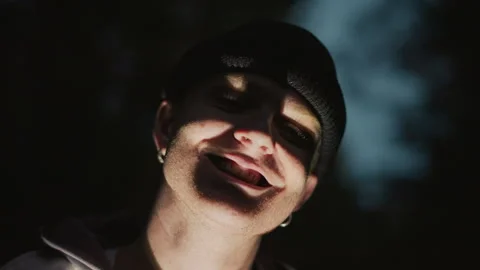 Hidden lighting accentuates ghostly features in night woods, Nighttime portrait Stock Footage 327761134