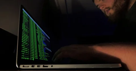 Hidden man issues commands to a computer Stock Footage 81948284