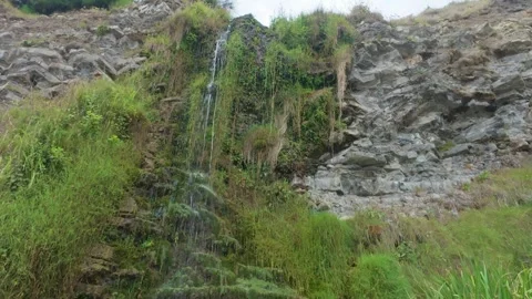Hidden Mossy Waterfall Flowing Through Rocky Cliff in Northern Spain Stock Footage 340150886