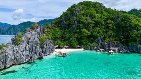 Hidden Paradise Beach with Limestone Cliffs and Boats Stock Photos