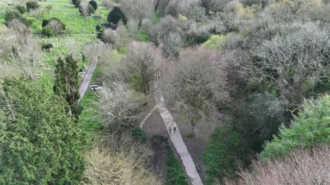 Hidden Pathway Beside Graveyard Aerial Drone Shot Stock Footage 334051254