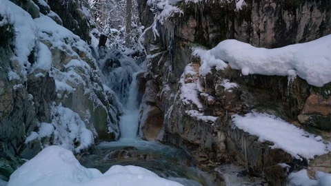 Hidden small waterfall in river in winter forest 4k loop Stock Footage 82623374