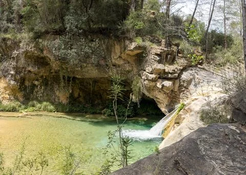 Hidden turquoise pool and small waterfall in canyon Stock Photos