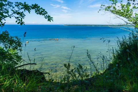 Hidden view of Baltic Sea through summer grass and coastal trees Stock-Fotos