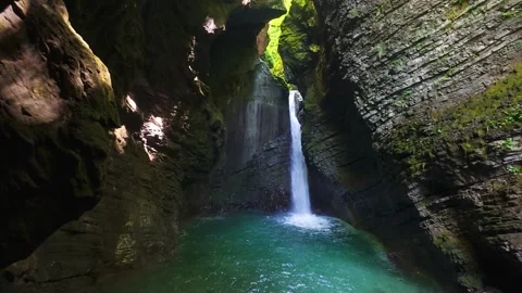 Hidden Waterfall Flowing Into Turquoise Pool Inside Rocky Canyon Stock Footage 337785381