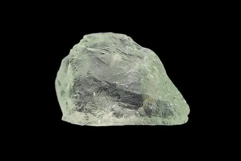 Hiddenite gemstone on dark background Photos