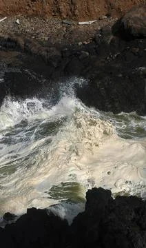 Hide tide waves foam in Devil's Churn Stock Photos