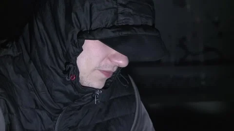 Hiding his face, suspect, crook, criminal, unsure. Stock Footage 58751124