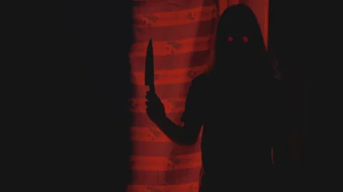 Hiding from the killer ghost with glowing eyes and a knife. Vintage horror. Red Stock Footage 246046849