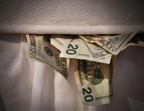 Hiding money in mattress Stock Photos