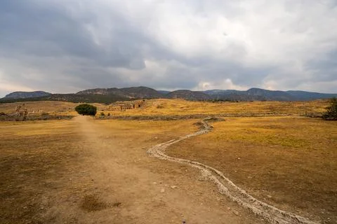 Hierapolis in Pamukkale: A desolate path winds through the arid landscape, .. Stock Photos