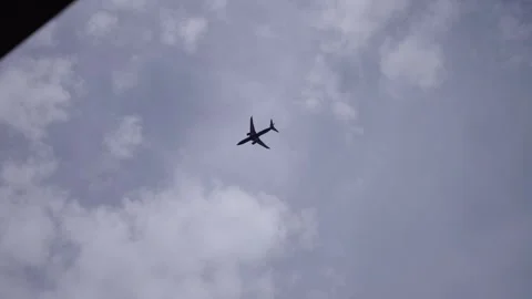 High above the clouds, an airplane glides gracefully through Stock Footage 320339556