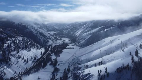 High above mountain valley in winter with hanging fog 動画素材 310570641