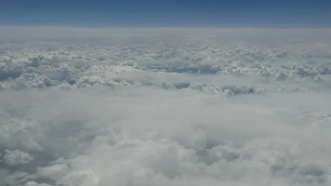 High above, vast clouds drift beneath clear blue sky 動画素材 347964452