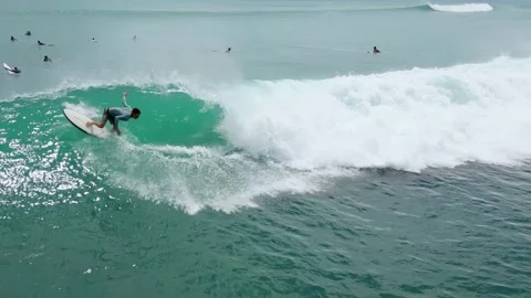 High Above View Showcasing Surfer Balancing On Crest Of Vibrant Blue Wave Stock Footage 326824242