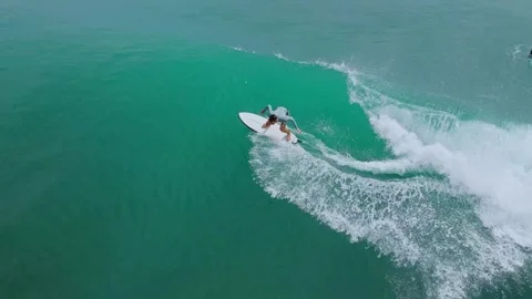 High Above View Showcasing Surfer Balancing On Crest Of Vibrant Blue Wave Stock Footage 326824253