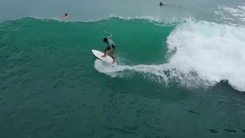 High Above View Showcasing Surfer Balancing On Crest Of Vibrant Blue Wave Stock Footage 327408482