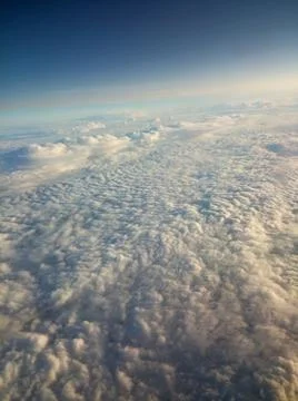 High above white fluffy clouds blue sky Stock Photos