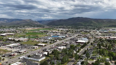 High aerial back away from Heber City Utah in spring with dramatic sky Stock Footage 335798400