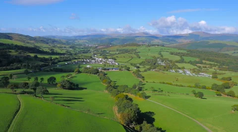 High aerial drone footage of a Welsh village set in stunning countryside Stock Footage